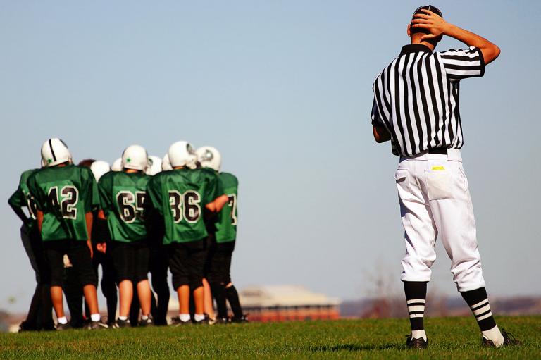 referee and youth football players