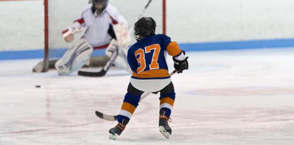 Youth player skating towards the net.